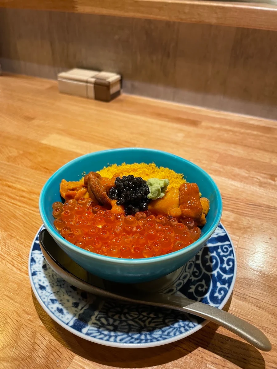 A carefully presented Japanese dish in a blue bowl