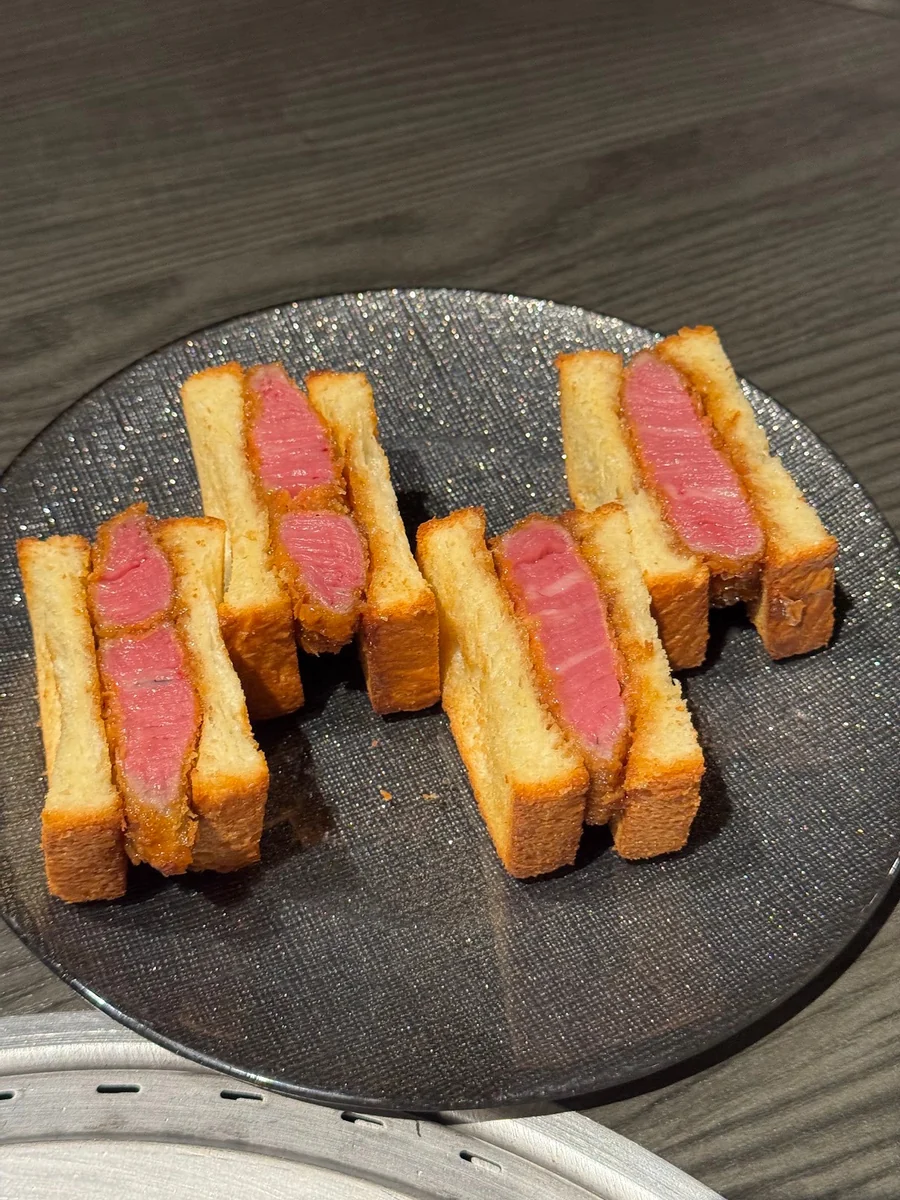 Food arranged on a dark ceramic plate