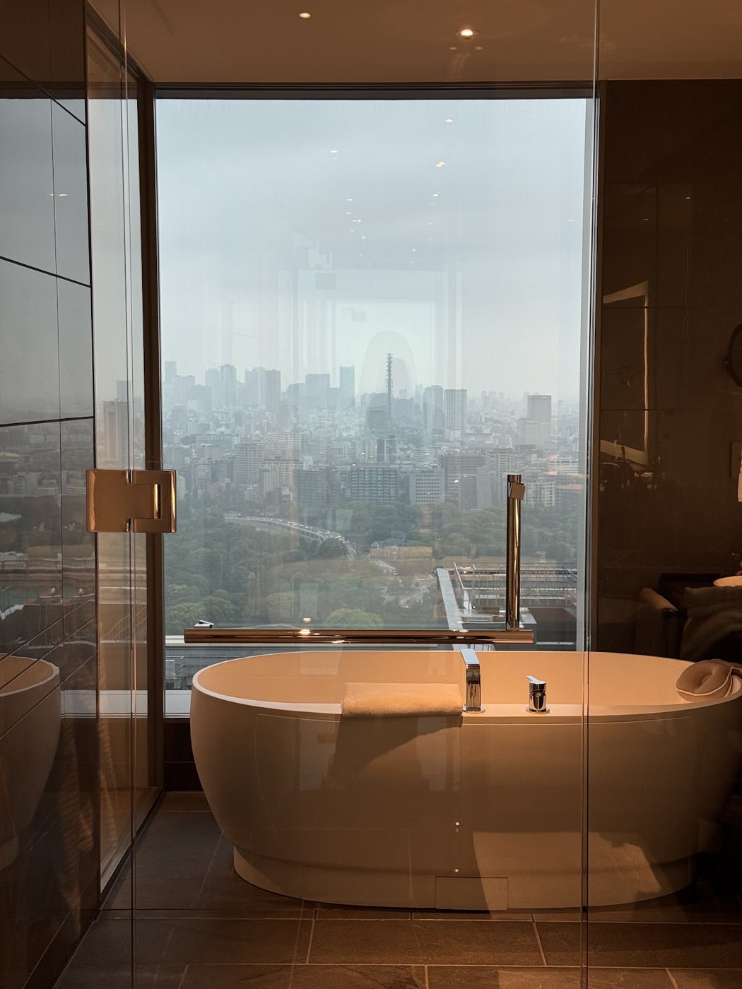 A bathtub beside floor-to-ceiling windows at Four Seasons Tokyo