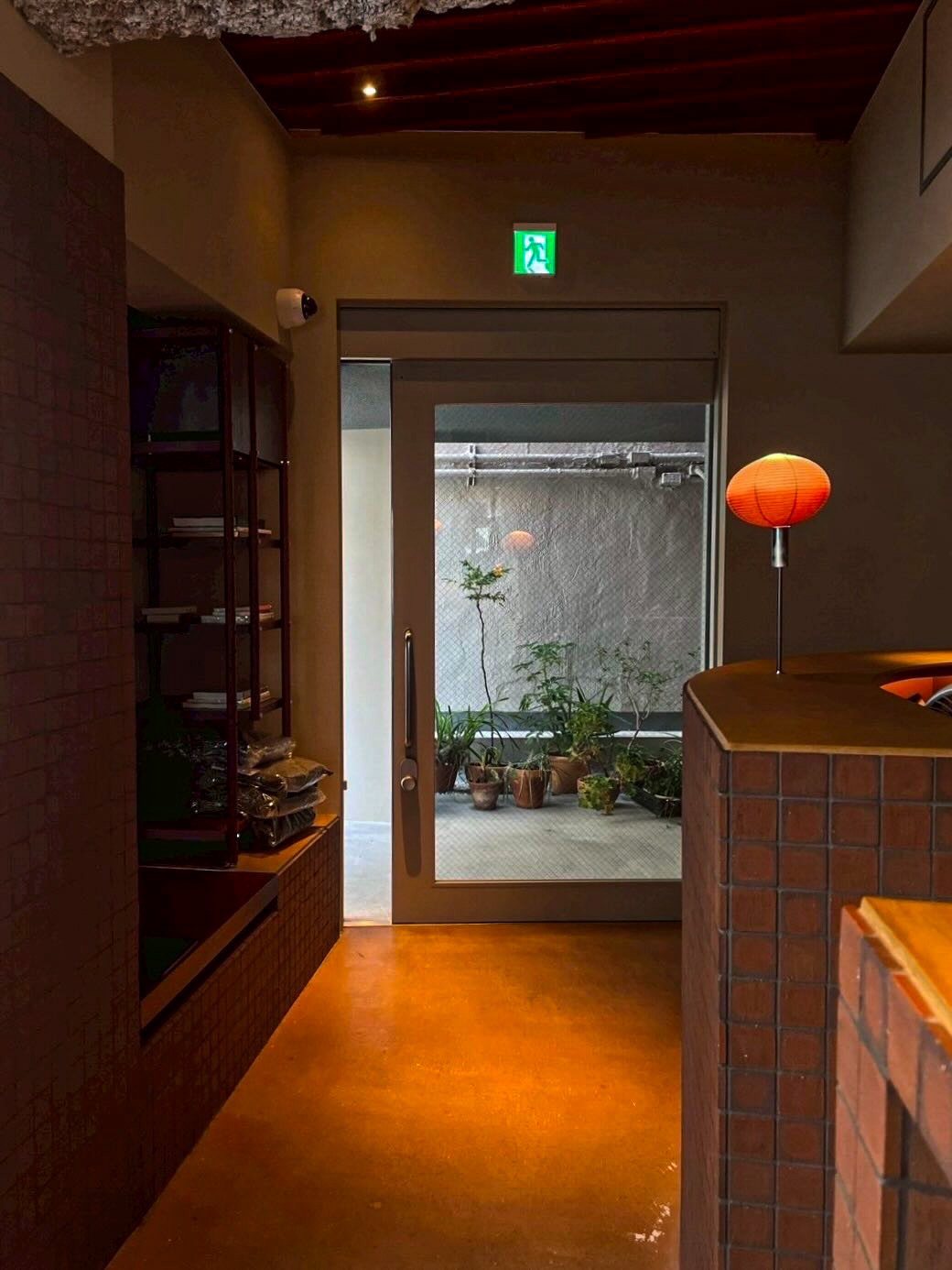 Interior at SOIL Nihonbashi looking onto a small planted courtyard