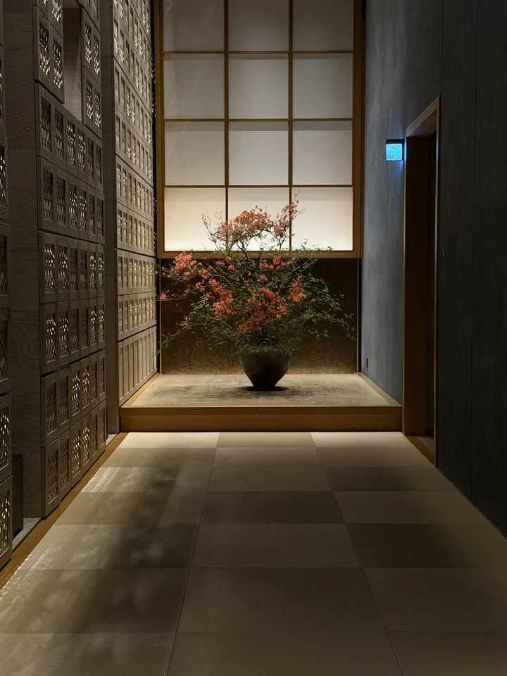 Shoji panels and a seasonal flower arrangement in a quiet Tokyo interior